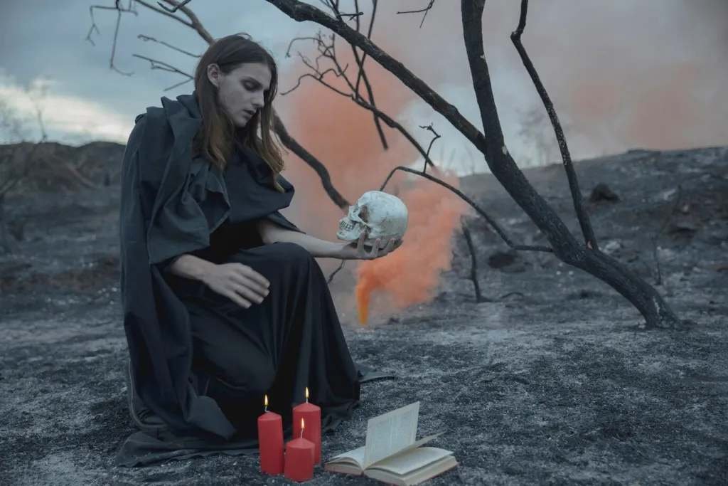 Woman sitting with a skull in his hand and looking at it