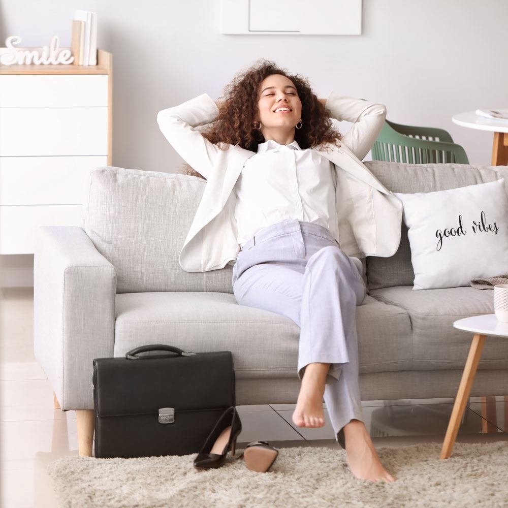 Person relaxing with briefcase and heels, mastering work-life balance in NYC.