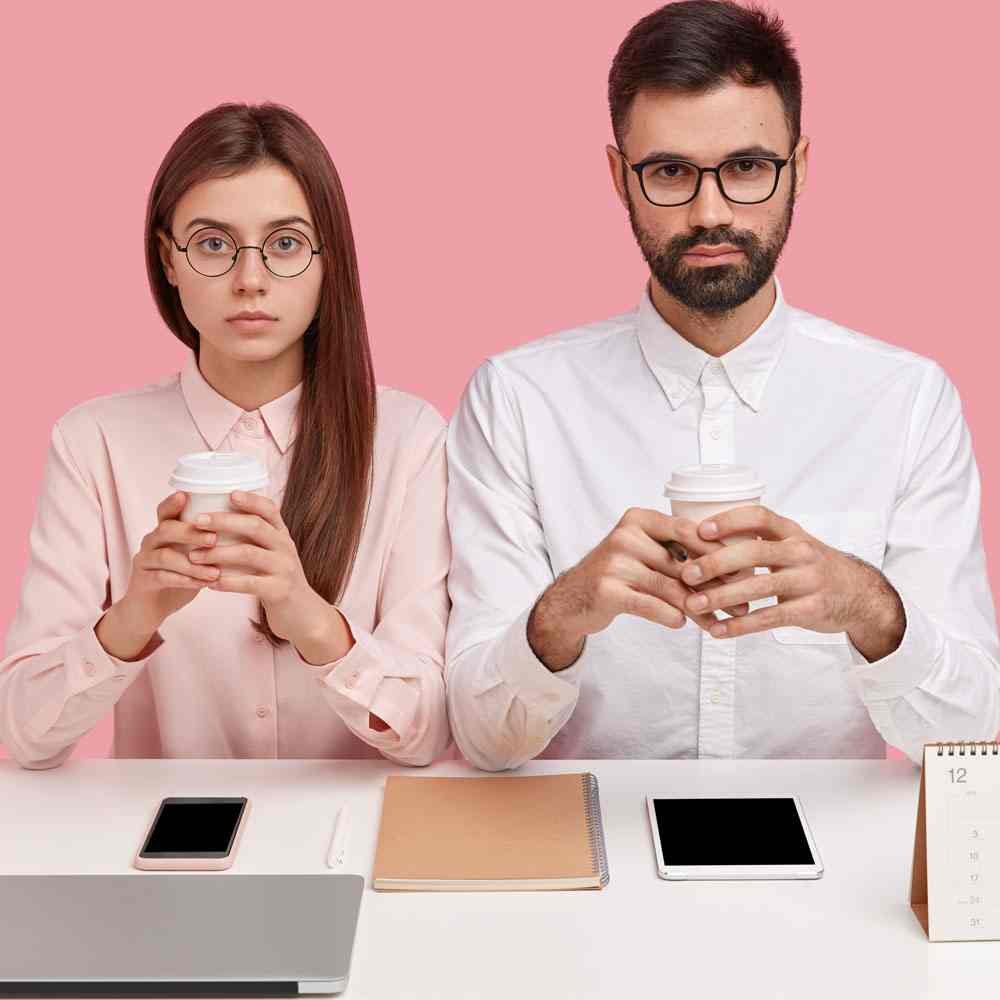 Two people with coffee cups and laptop, overcoming perfectionism in relationships in NYC.