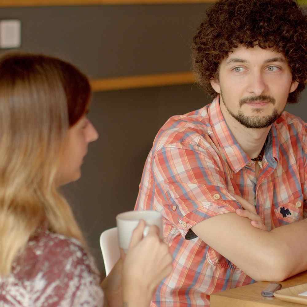 Two people chatting with a white mug, exploring platonic relationships in NYC.