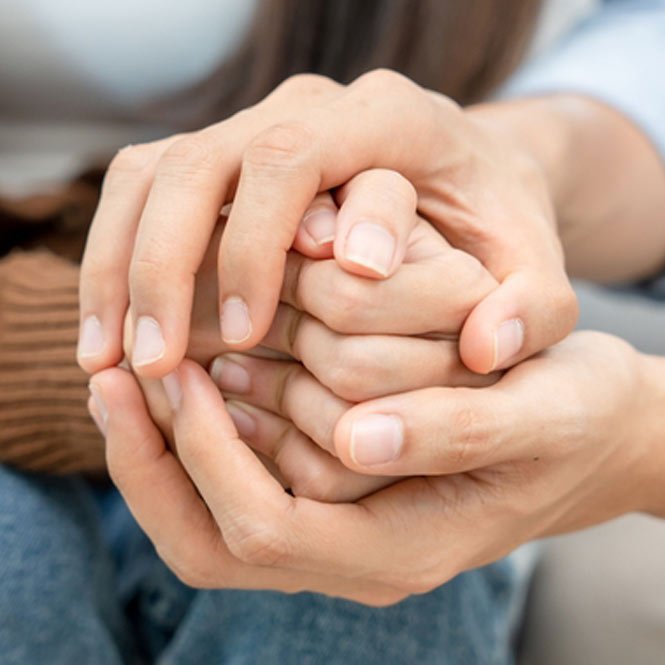 Couples hold hands to support each other while discussing family issues