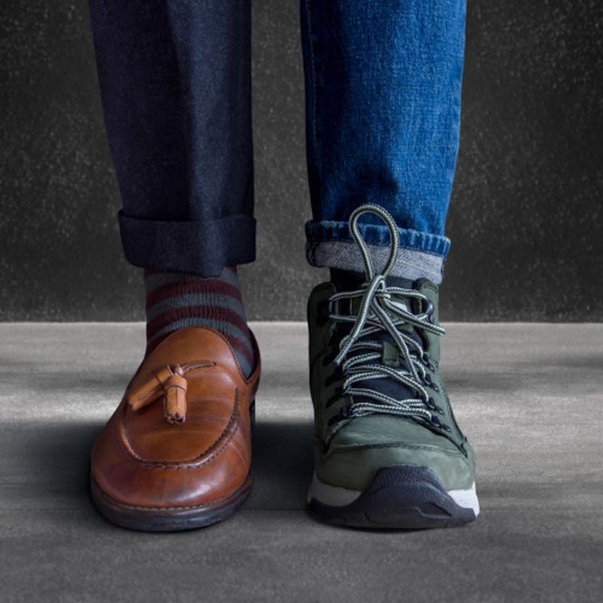 Low Section of a Man Standing with Half of Working Shoes and Casual Traveling Shoes