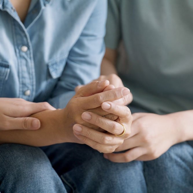 Adult child help old mom crying grief loss hold hand stress relief talk with love care at home.