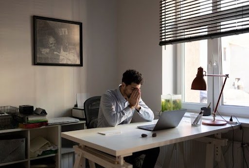 Woman in a workplace setting managing anxiety, symbolizing mental health at work.