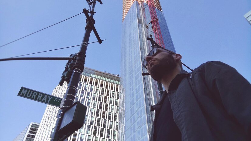Low angle view of man standing against building in New York City