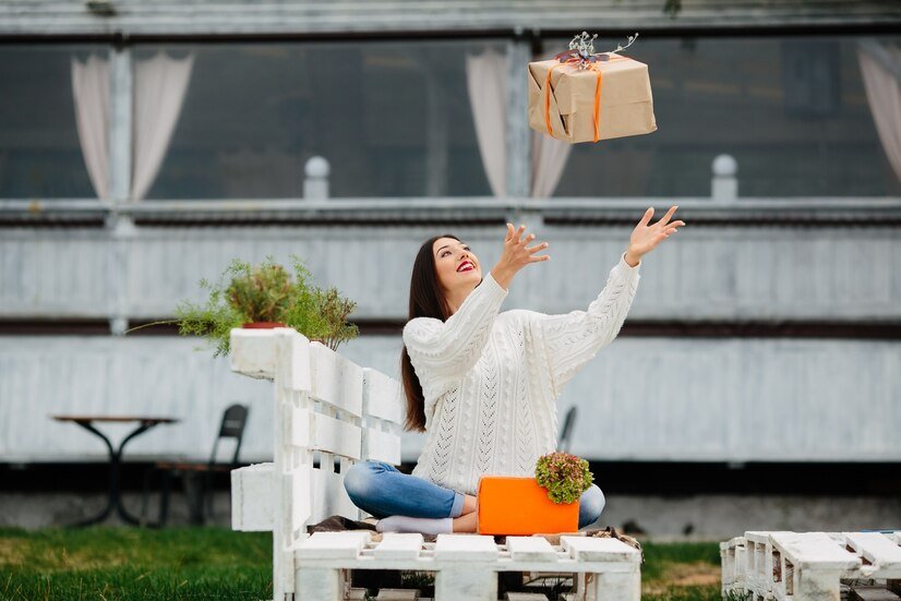 live in the present with joy and fulfillment - a woman throwing a gift in the air