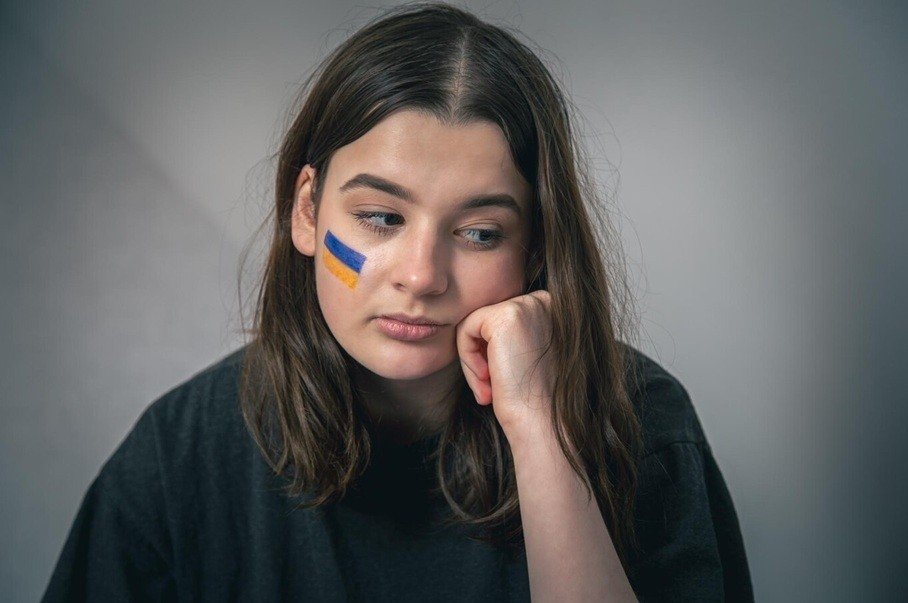 girl with a painted flag of ukraine on her face