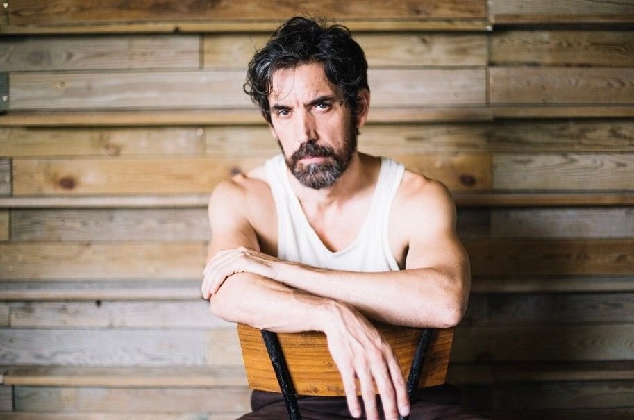 toxic masculinity - a man posing on chair