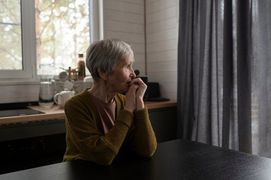 anxiety in older adults - senior woman sitting at table